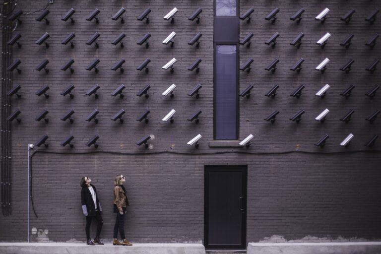 “Women viewing modern art with black and white surveillance cameras on wall in Toronto” by Matthew Henry on Unsplash
